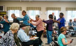 An bunch of elderly people in a room