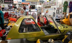 A yellow snowmobile that looks like a car