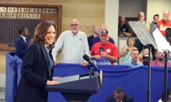 Kamala Harris, wearing a dark blue pant suit, speaks to supporters