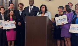 Michigan House Democrats on a press conference. Some are holding signs that says "Strong Schools. Healthy Kids"