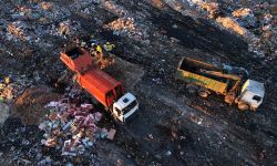 Garbage truck unloads rubbish in landfill.