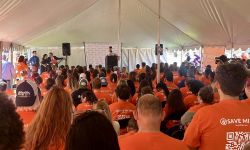 A group of people wearing orange shirts that says "Save MI tips"