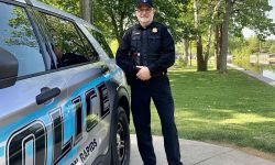 Chief Larry Joe Weeks poses next to an Eaton Rapids police car