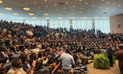 Detroit Mayor Mike Duggan speaking into a crowded room