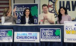 Gov. Gretchen Whitmer sitting at a table with state Rep. Jamie Churches and Michigan House candidates Janise O’Neil Robinson and Kyle Wrigh